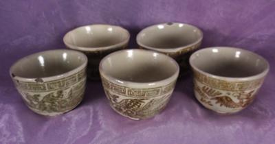 brown and tan teacups with dragons