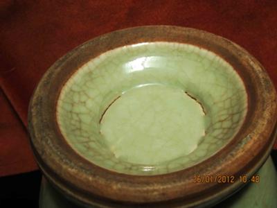 The base, indicating the vessel was fired in a kiln with sand on the bottom, preventing the glaze from coating the bottom rim